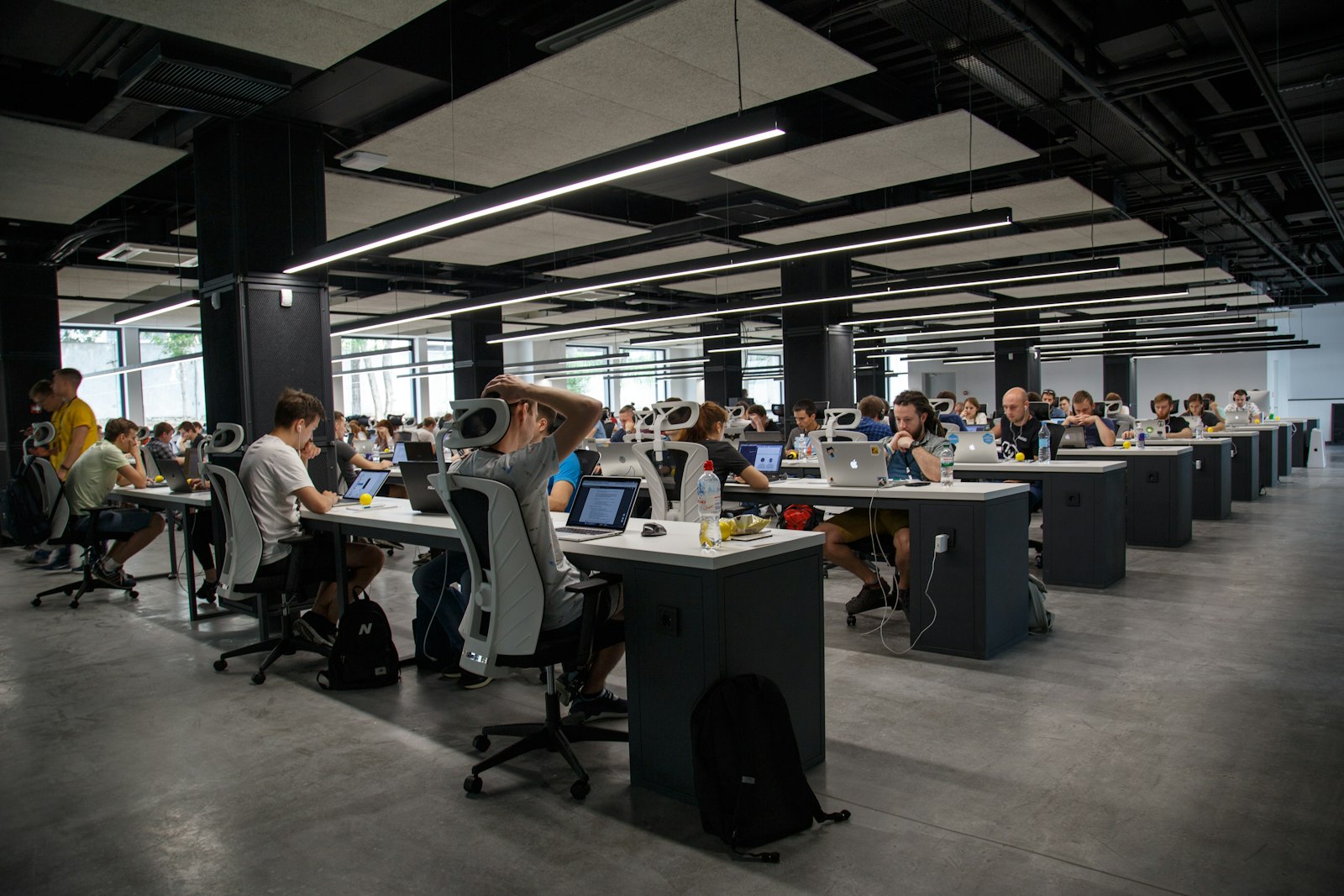A large open-plan engineering floor with teams working at rows of desks