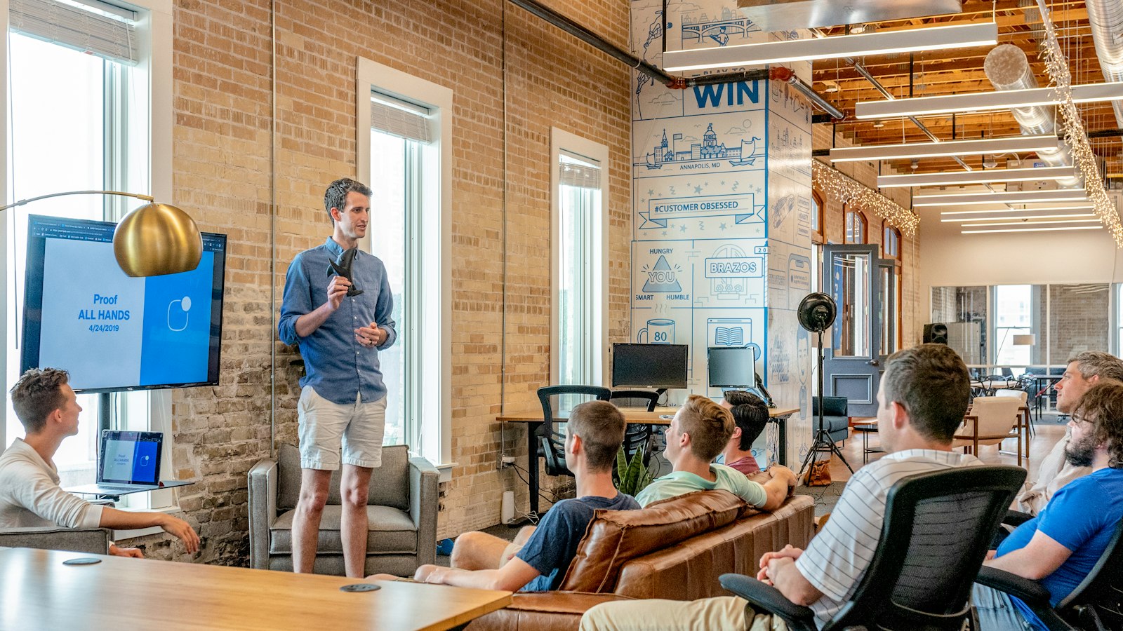 A team being walked through a technical plan in a bright, open workspace